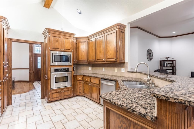 2525 Steeplechase Rd, Edmond, OK 73034 - kitchen featuring stainless steel appliances, brown cabinetry, stone countertops, backsplash, and recessed lighting