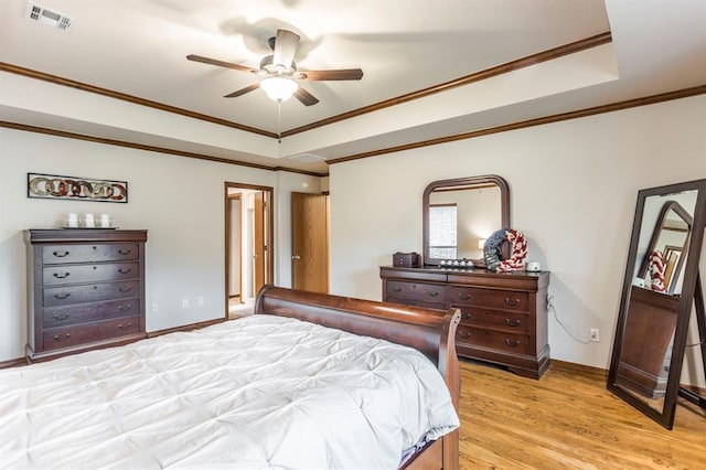 2525 Steeplechase Rd, Edmond, OK 73034 - bedroom featuring a raised ceiling, crown molding, light wood finished floors, and ceiling fan