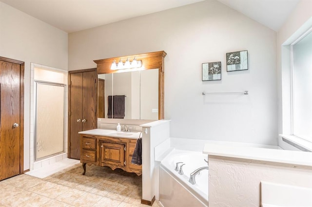 2525 Steeplechase Rd, Edmond, OK 73034 - bathroom featuring vanity, a garden tub, a shower stall, vaulted ceiling, and tile patterned floors
