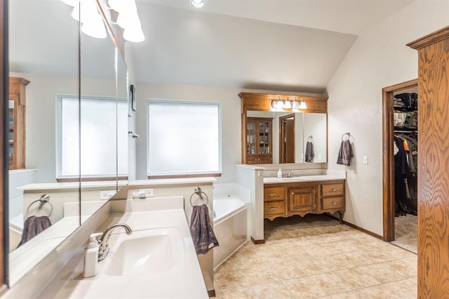 2525 Steeplechase Rd, Edmond, OK 73034 - bathroom with lofted ceiling, a garden tub, vanity, tile patterned flooring, and a spacious closet