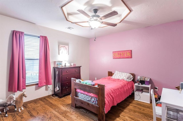 2525 Steeplechase Rd, Edmond, OK 73034 - bedroom with multiple windows, wood finished floors, and ceiling fan