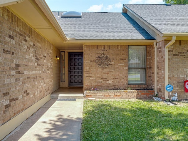 3213 Creekwood Ct, Norman, OK 73072 - property entrance featuring a shingled roof, brick siding, and a yard