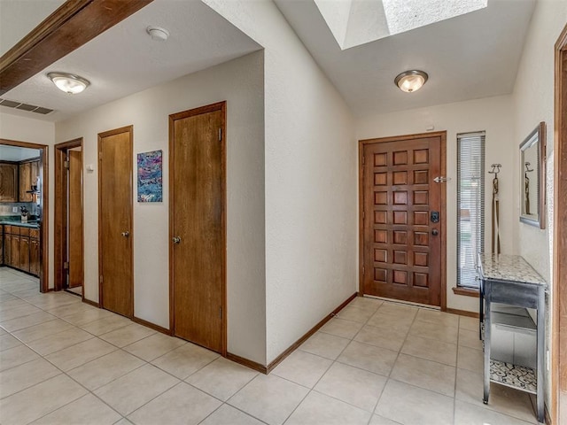 3213 Creekwood Ct, Norman, OK 73072 - entryway featuring a skylight and light tile patterned floors