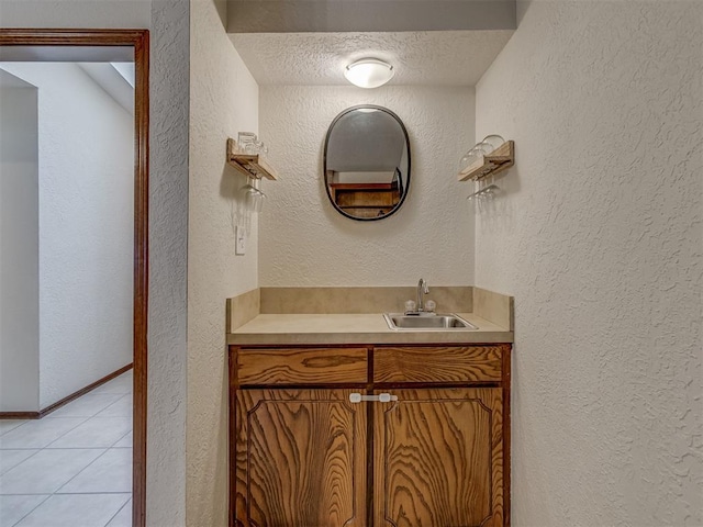 3213 Creekwood Ct, Norman, OK 73072 - bathroom with vanity, tile patterned flooring, and a textured wall