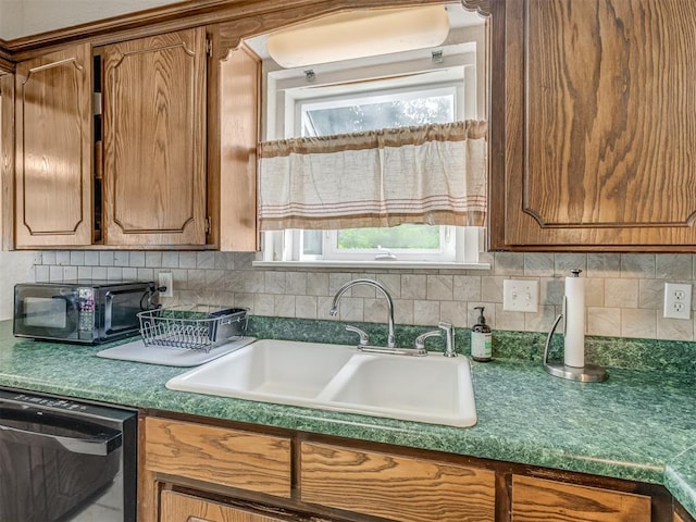 3213 Creekwood Ct, Norman, OK 73072 - kitchen with dishwasher, black microwave, brown cabinetry, and tasteful backsplash