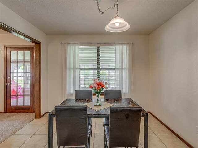3213 Creekwood Ct, Norman, OK 73072 - dining area with a textured ceiling and light tile patterned flooring