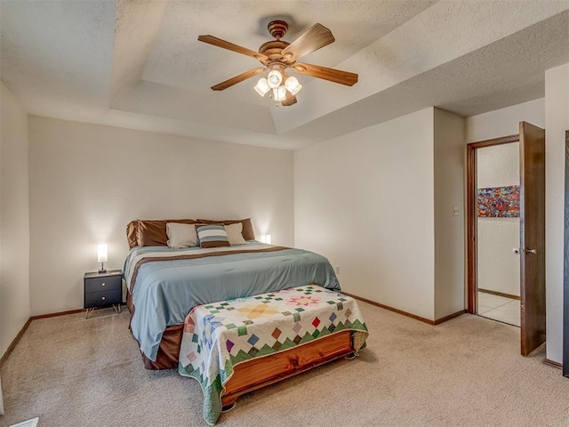 3213 Creekwood Ct, Norman, OK 73072 - carpeted bedroom featuring a tray ceiling, a textured ceiling, and ceiling fan