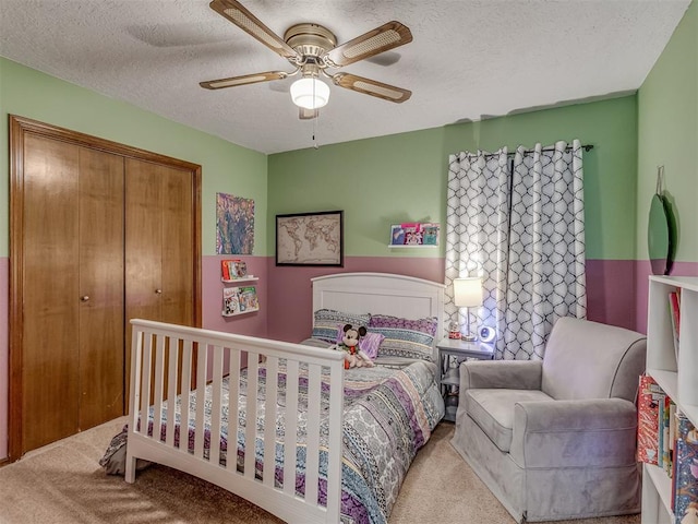 3213 Creekwood Ct, Norman, OK 73072 - carpeted bedroom with a textured ceiling, a closet, and a ceiling fan
