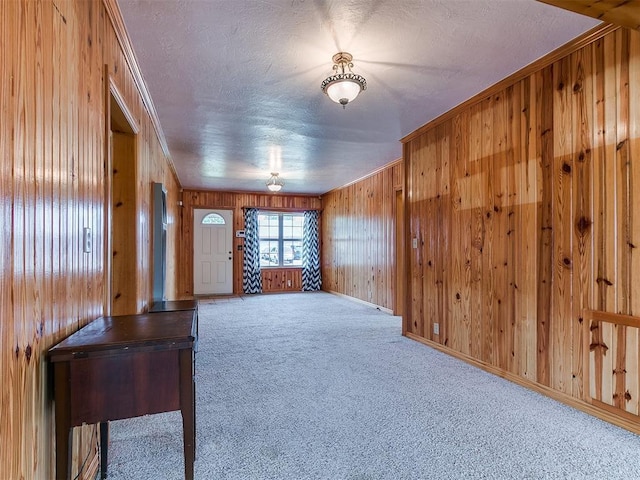 1016 Maple Ave, Yukon, OK 73099 - carpeted foyer entrance featuring wooden walls, a textured ceiling, and crown molding