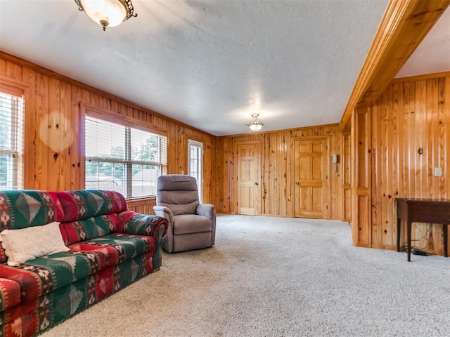 1016 Maple Ave, Yukon, OK 73099 - living area featuring wooden walls, carpet floors, crown molding, and a textured ceiling