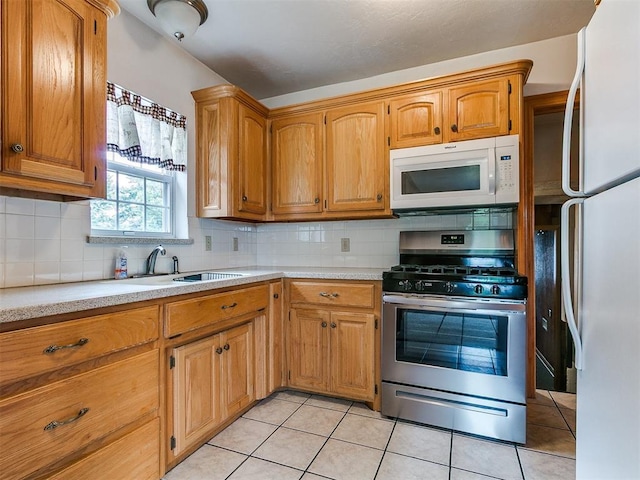 1016 Maple Ave, Yukon, OK 73099 - kitchen with white appliances, light countertops, backsplash, and light tile patterned floors