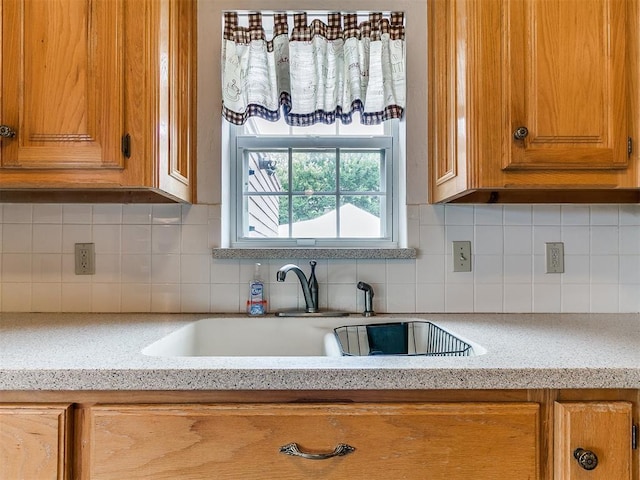 1016 Maple Ave, Yukon, OK 73099 - kitchen featuring light countertops, brown cabinetry, and tasteful backsplash