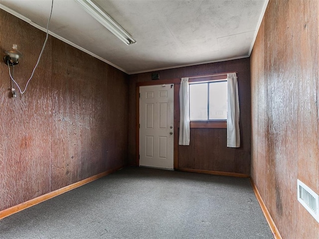 1016 Maple Ave, Yukon, OK 73099 - unfurnished room featuring carpet floors and wood walls