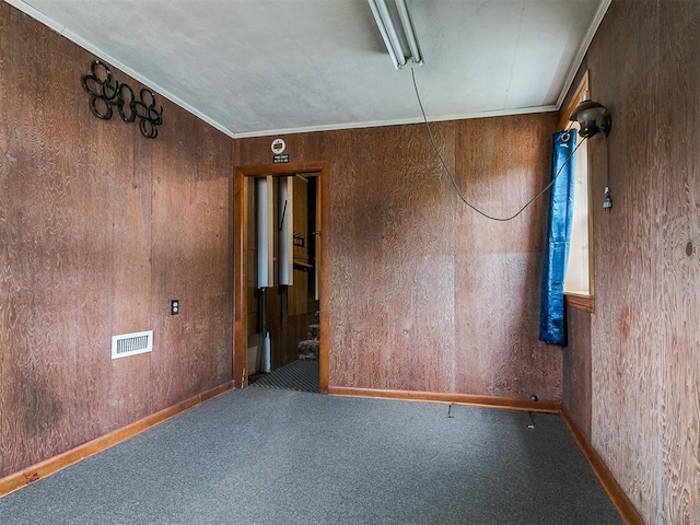 1016 Maple Ave, Yukon, OK 73099 - spare room with carpet flooring and wooden walls