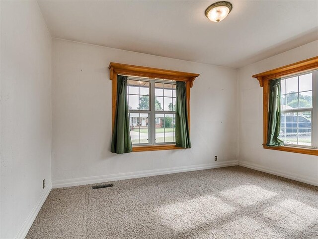 1016 Maple Ave, Yukon, OK 73099 - spare room featuring carpet and healthy amount of natural light