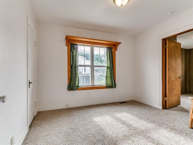 1016 Maple Ave, Yukon, OK 73099 - carpeted spare room featuring a smoke detector and baseboards