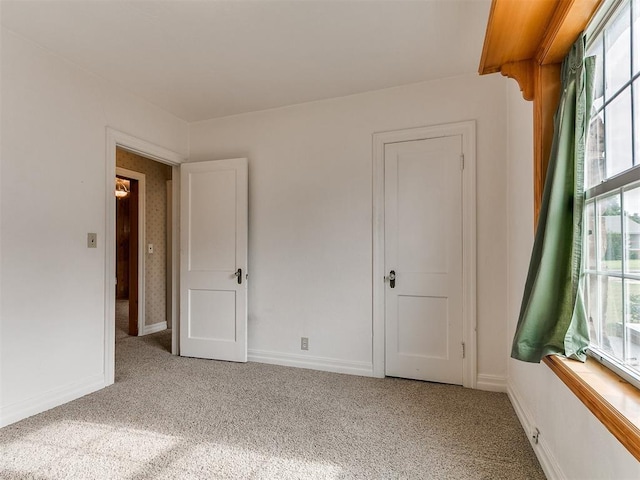 1016 Maple Ave, Yukon, OK 73099 - unfurnished bedroom with light carpet and multiple windows