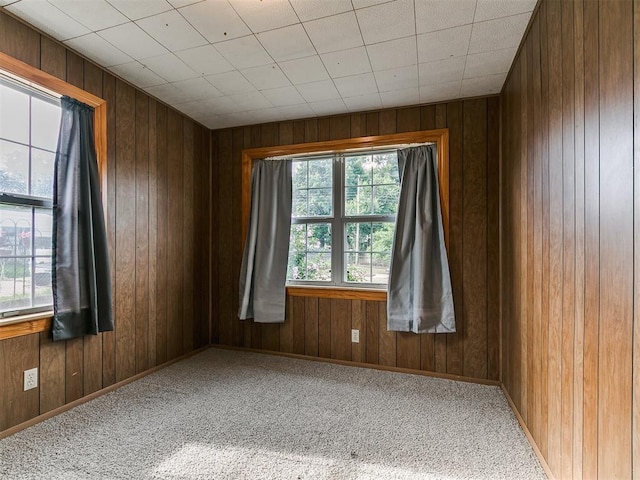 1016 Maple Ave, Yukon, OK 73099 - carpeted spare room featuring wood walls