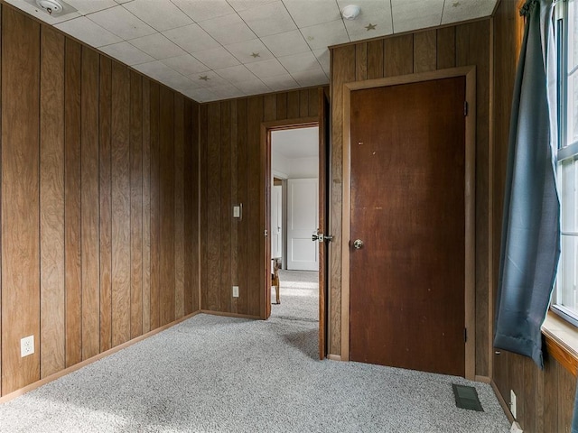 1016 Maple Ave, Yukon, OK 73099 - carpeted empty room featuring wooden walls and baseboards