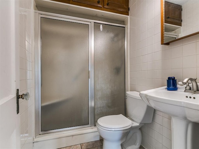 1016 Maple Ave, Yukon, OK 73099 - bathroom with tile walls, a stall shower, and tasteful backsplash