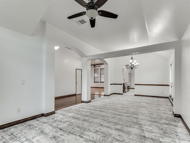 18501 El Greco Dr, Edmond, OK 73012 - unfurnished living room featuring arched walkways, a chandelier, lofted ceiling, ceiling fan, and wood finished floors