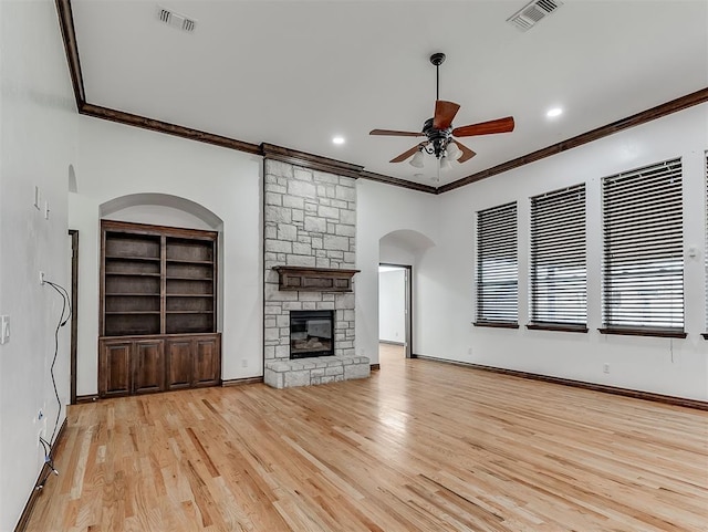18501 El Greco Dr, Edmond, OK 73012 - unfurnished living room featuring a ceiling fan, ornamental molding, a stone fireplace, light wood-style flooring, and recessed lighting