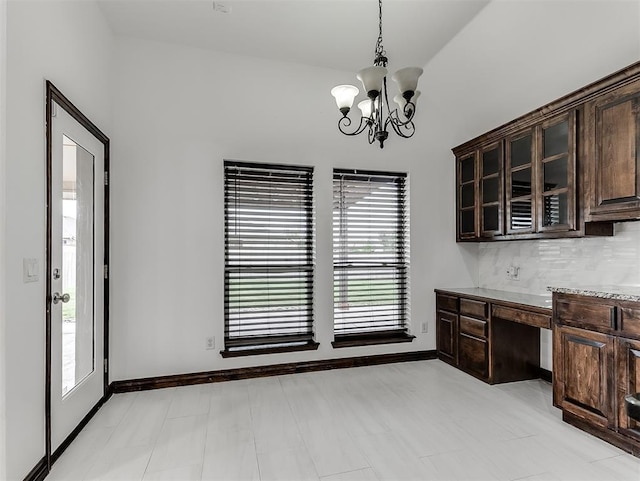 18501 El Greco Dr, Edmond, OK 73012 - unfurnished dining area featuring a chandelier and built in study area