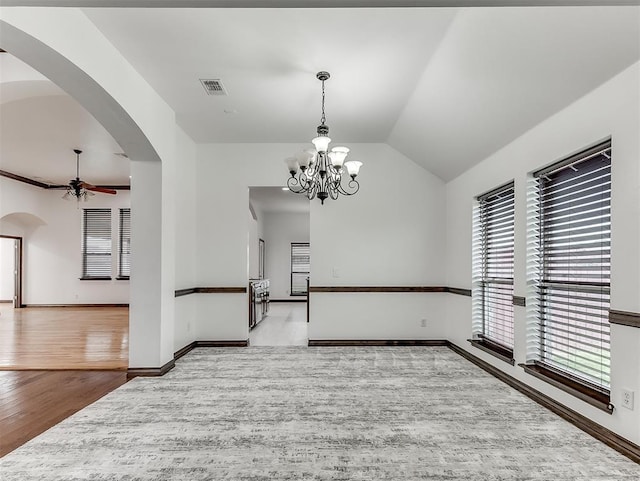 18501 El Greco Dr, Edmond, OK 73012 - unfurnished room with plenty of natural light, ceiling fan, arched walkways, wood finished floors, and lofted ceiling