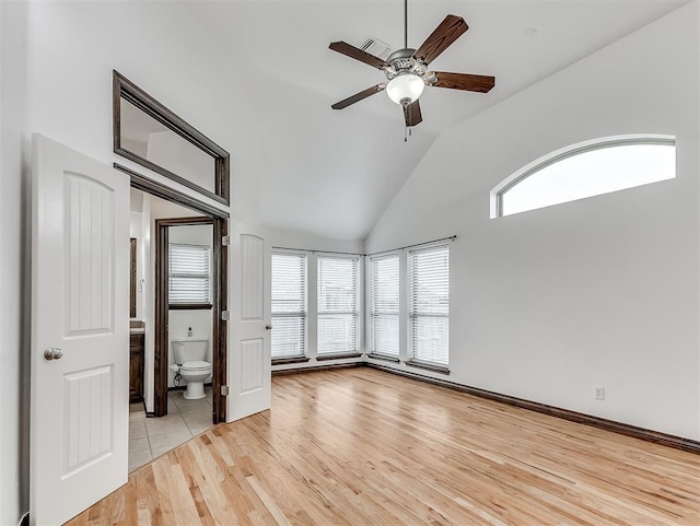 18501 El Greco Dr, Edmond, OK 73012 - unfurnished room with healthy amount of natural light, ceiling fan, light wood-type flooring, and high vaulted ceiling