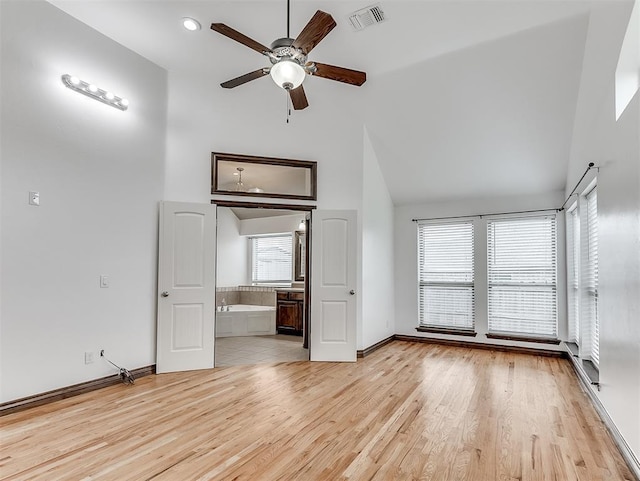 18501 El Greco Dr, Edmond, OK 73012 - unfurnished living room featuring high vaulted ceiling, ceiling fan, light wood-style flooring, and recessed lighting