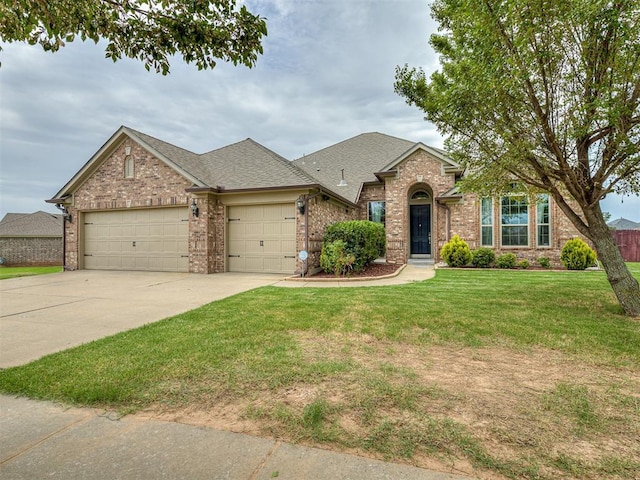 18501 El Greco Dr, Edmond, OK 73012 - traditional-style home with an attached garage, brick siding, driveway, a front yard, and a shingled roof