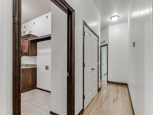 18501 El Greco Dr, Edmond, OK 73012 - hallway featuring baseboards and light wood-style floors