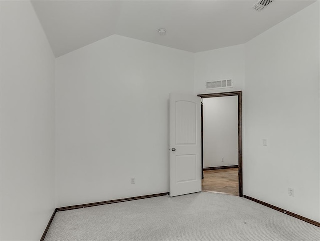 18501 El Greco Dr, Edmond, OK 73012 - carpeted empty room featuring vaulted ceiling and baseboards