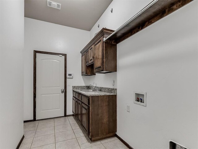 18501 El Greco Dr, Edmond, OK 73012 - laundry room with cabinet space, hookup for a washing machine, and light tile patterned floors