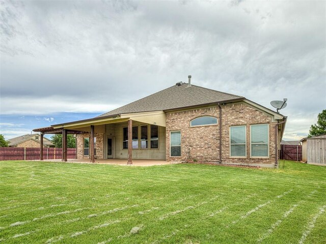 18501 El Greco Dr, Edmond, OK 73012 - back of house featuring a patio, a fenced backyard, brick siding, and a shingled roof