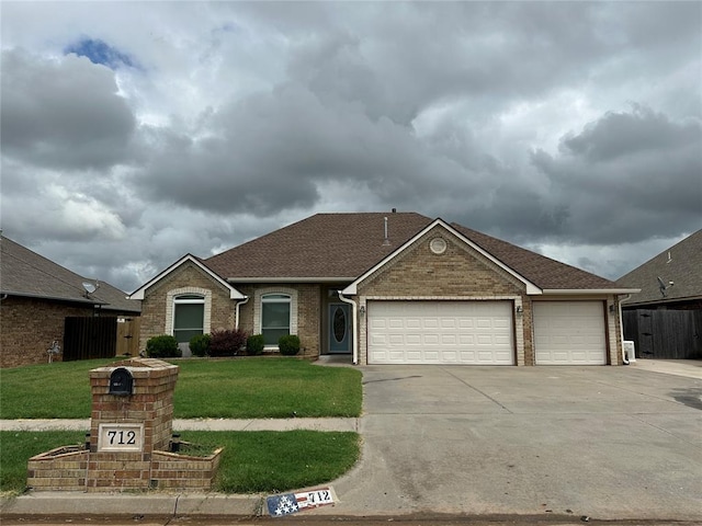 712 N Cherokee Way, Mustang, OK 73064 - view of front facade featuring a garage, concrete driveway, brick siding, and a shingled roof