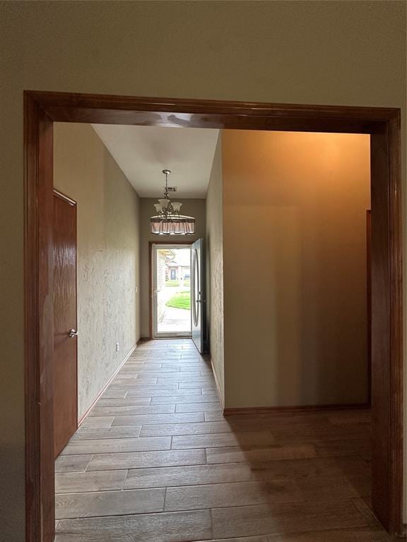 712 N Cherokee Way, Mustang, OK 73064 - hall with light wood finished floors and a chandelier
