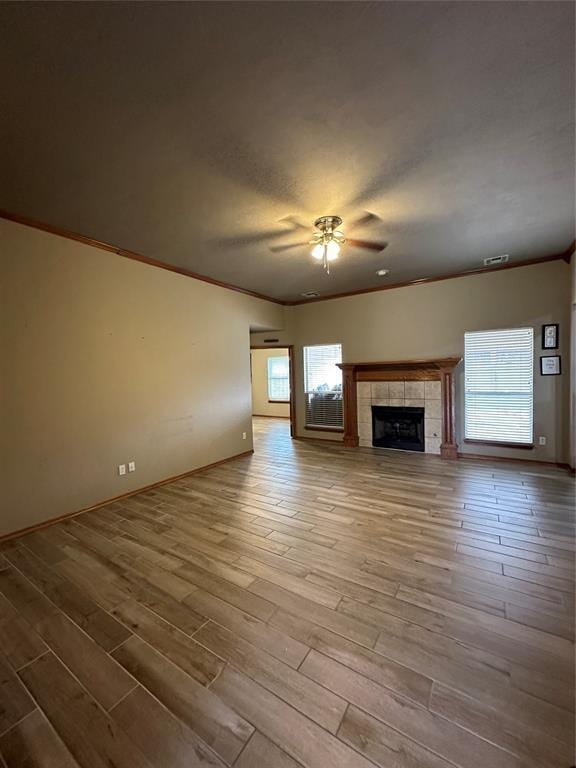 712 N Cherokee Way, Mustang, OK 73064 - unfurnished living room featuring ceiling fan, healthy amount of natural light, crown molding, and wood finished floors