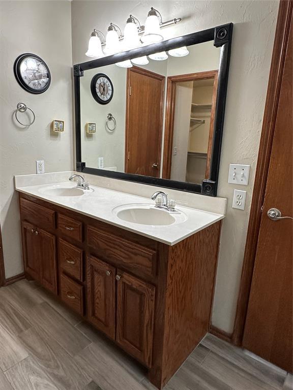712 N Cherokee Way, Mustang, OK 73064 - full bath featuring double vanity and wood finished floors