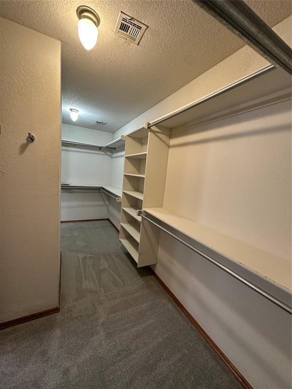 712 N Cherokee Way, Mustang, OK 73064 - walk in closet featuring dark colored carpet
