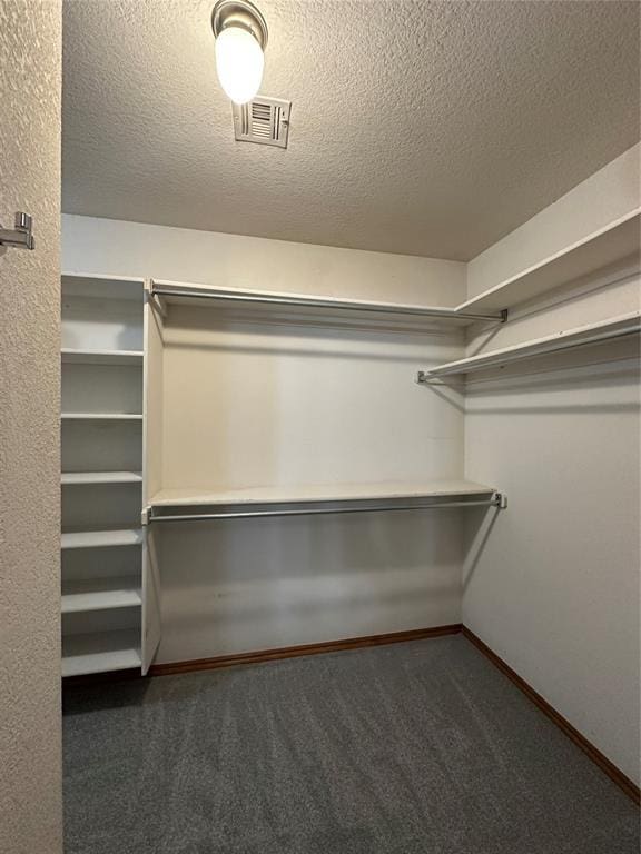 712 N Cherokee Way, Mustang, OK 73064 - walk in closet with carpet floors