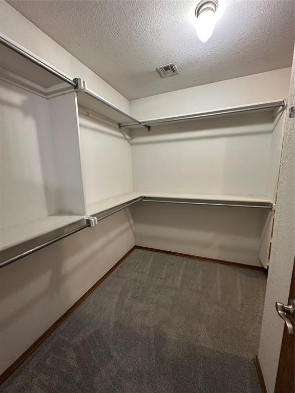 712 N Cherokee Way, Mustang, OK 73064 - spacious closet featuring carpet floors