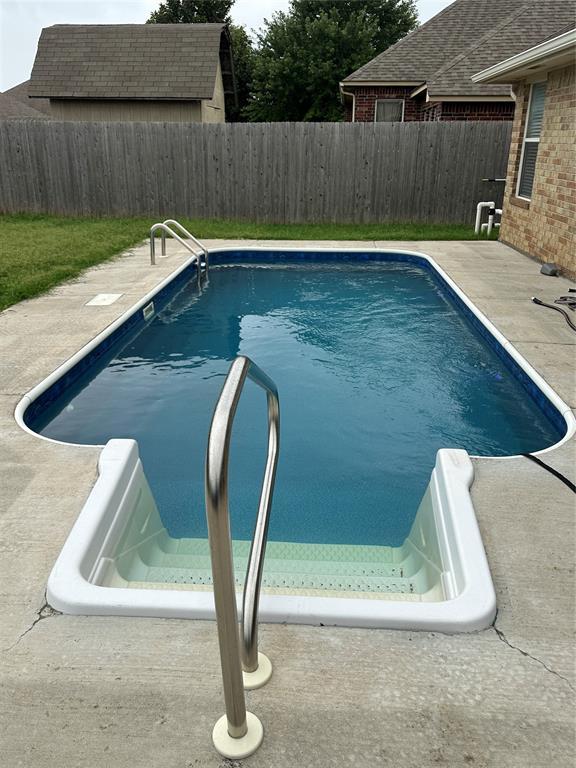712 N Cherokee Way, Mustang, OK 73064 - view of swimming pool featuring a fenced backyard and a patio