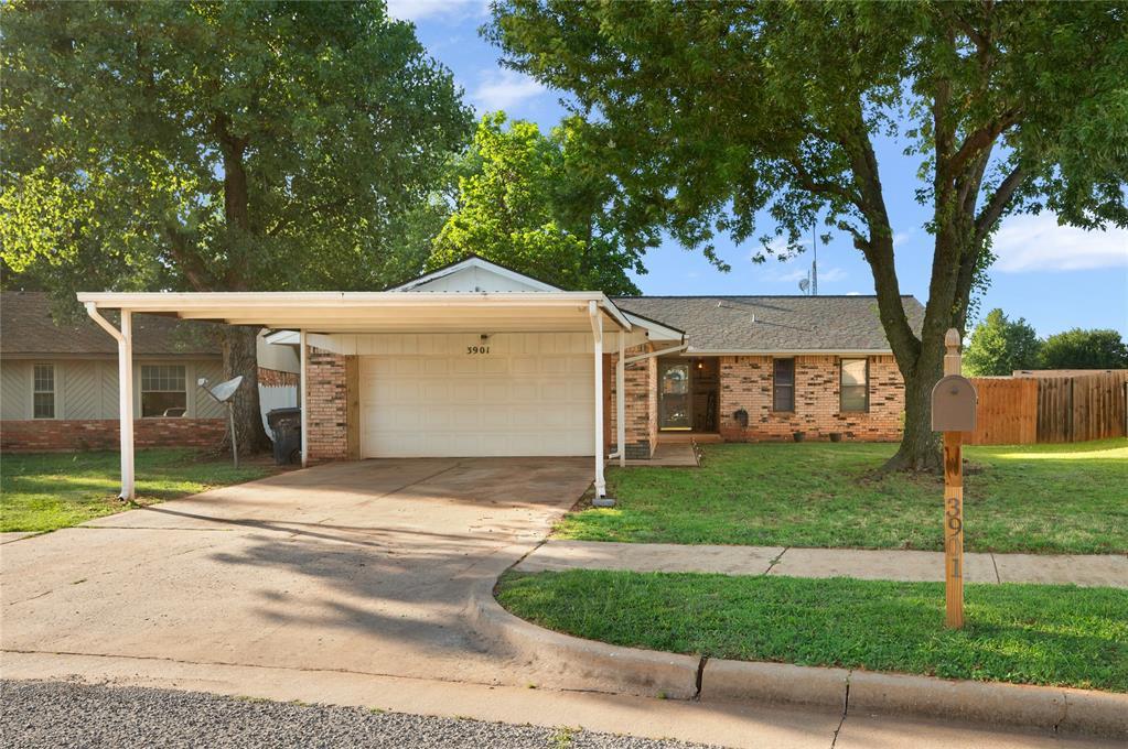 3901 Oak Valley Rd, Oklahoma City, OK 73135 - single story home featuring a garage, brick siding, and driveway