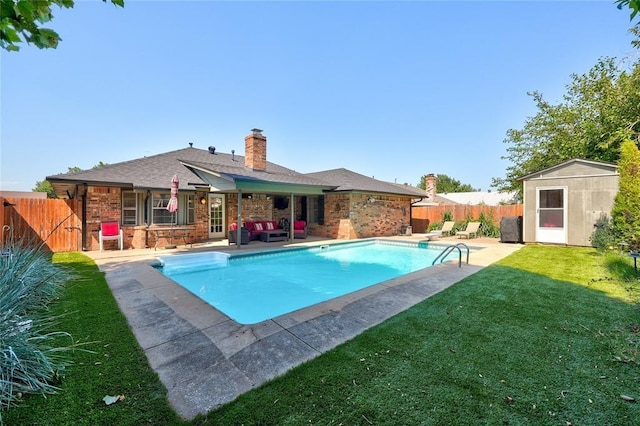1040 Mabel C Fry Blvd, Yukon, OK 73099 - view of pool featuring outdoor lounge area, a fenced backyard, a patio, and a storage unit