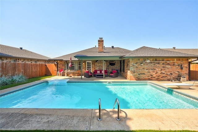 1040 Mabel C Fry Blvd, Yukon, OK 73099 - view of swimming pool featuring outdoor lounge area, a fenced backyard, a patio, and a diving board