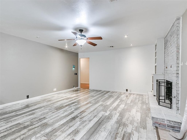 1040 Mabel C Fry Blvd, Yukon, OK 73099 - unfurnished living room with light wood-style floors, a ceiling fan, a fireplace, and recessed lighting