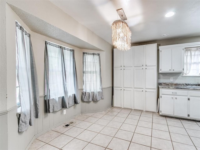 1040 Mabel C Fry Blvd, Yukon, OK 73099 - kitchen featuring a chandelier, white cabinetry, light tile patterned flooring, and decorative backsplash
