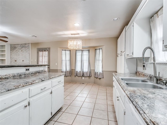 1040 Mabel C Fry Blvd, Yukon, OK 73099 - kitchen with white cabinetry, tasteful backsplash, light tile patterned floors, a chandelier, and light countertops