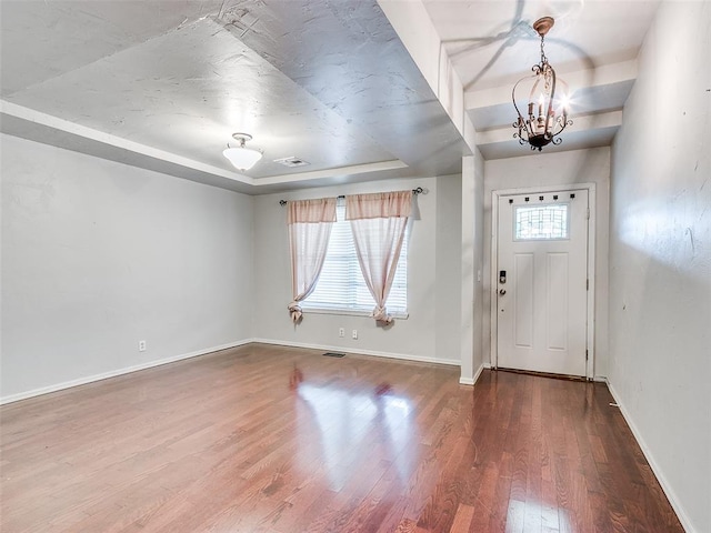 1040 Mabel C Fry Blvd, Yukon, OK 73099 - foyer featuring a raised ceiling, wood finished floors, and a chandelier
